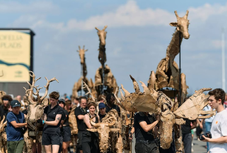 Artists parade animal figures in festival